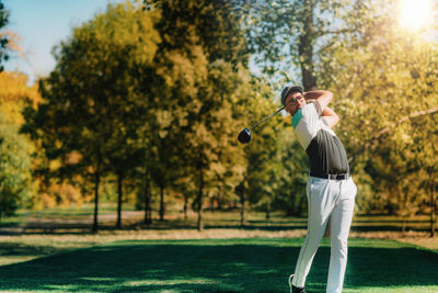 Young golfer hitting the ball