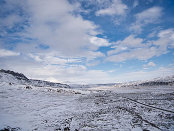 Scenic view of snowcapped landscape against sky