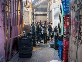 People walking on street amidst buildings in city