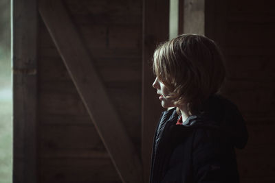 Side view of boy looking at camera