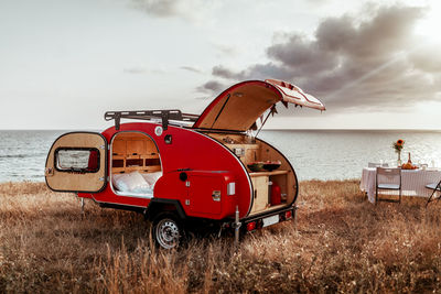 Cozy camping on the background of the sea, traveling by car, traveling with a camper