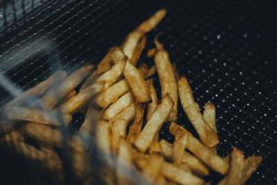 Close-up of meat on metal grate