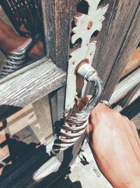 Close-up of hand holding rusty metal