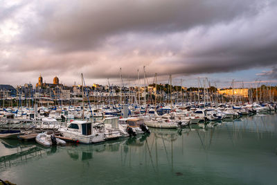 Boats in marina at sunset