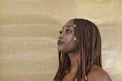 Young woman with braided hair looking away