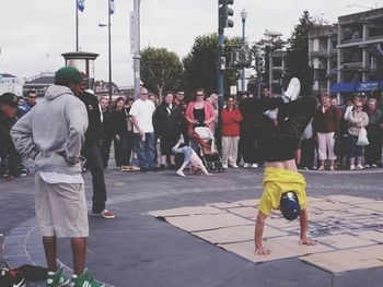 People on sidewalk in city