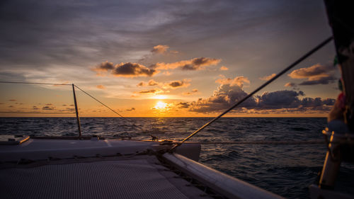 Sailboat on sea against sky during sunset