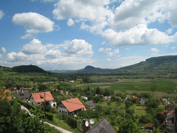 Scenic view of landscape and houses against sky