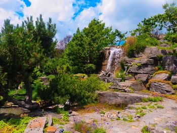 Scenic view of waterfall against sky