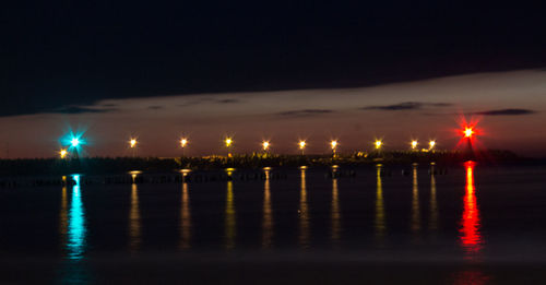 Reflection of illuminated lights in puddle