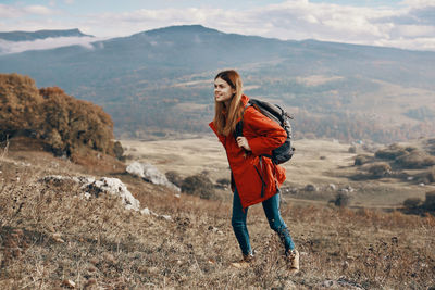 Full length of man standing on mountain against sky