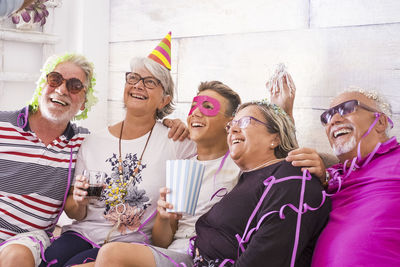 Cheerful family sitting on sofa at home during celebration