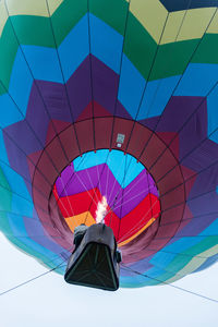 Low angle view of hot air balloon flying against sky