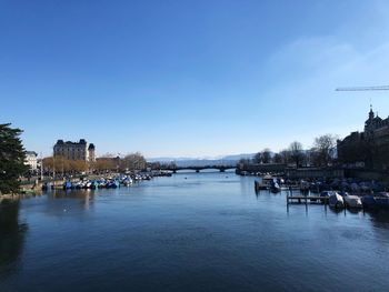 Bridge over river against buildings in city
