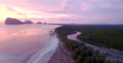 Panoramic view of road by sea against sky during sunset