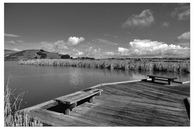 Scenic view of pier over lake against sky