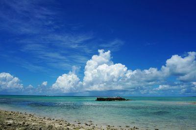 Scenic view of sea against cloudy sky