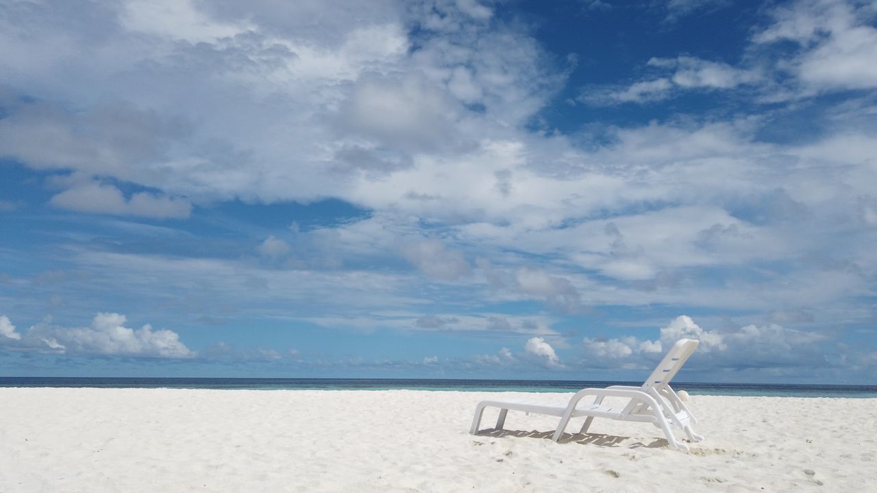 CHAIR ON BEACH AGAINST SKY