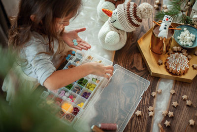 High angle view of girl holding table