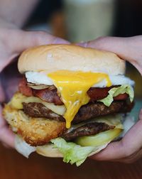 Close-up of hand holding burger