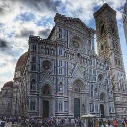 Low angle view of tourists in front of building