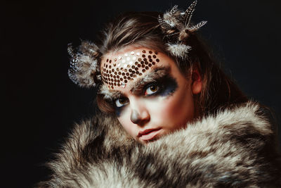 Portrait of young woman in animal face paint