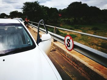 Car on trees against sky