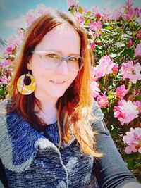 Portrait of beautiful young woman with red flower