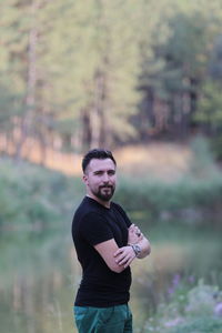 Portrait of young man standing on field