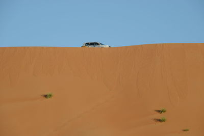 Scenic view of desert against clear sky