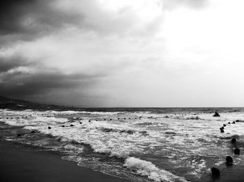 Scenic view of sea against cloudy sky