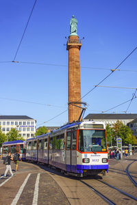 View of railroad tracks against clear blue sky
