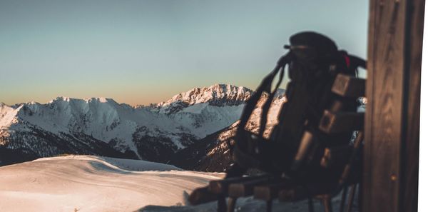 People standing on snowcapped mountain against sky