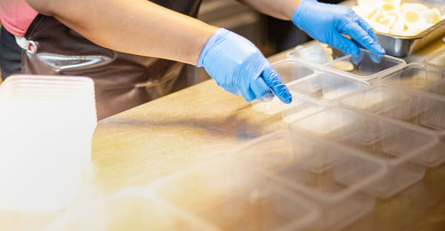 Midsection of man working on table