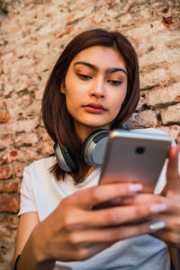 Portrait of young woman using mobile phone