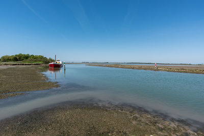 Scenic view of sea against clear blue sky