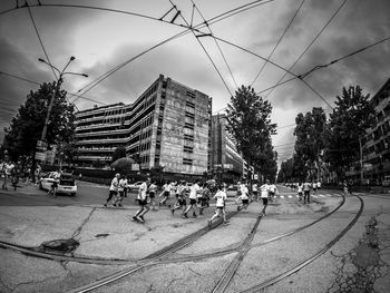 People on street against buildings in city