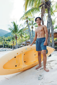 Low section of woman in boat on beach