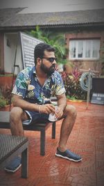 Young man sitting on chair