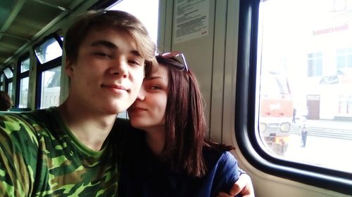 Portrait of couple sitting in train