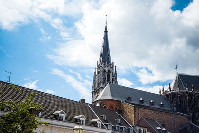 Low angle view of aachen cathedral against cloudy sky