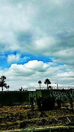 Scenic view of landscape against cloudy sky