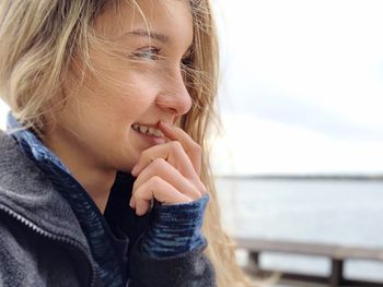 Close-up of young woman looking away in city