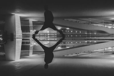 Rear view of woman with arms outstretched against sky