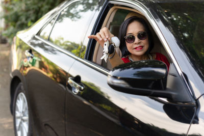 Portrait of woman with sunglasses in car