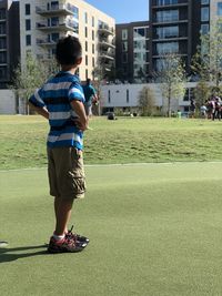 Full length of man standing by building in city