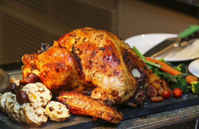 Close-up of roasted chicken on slate