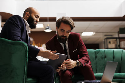 Side view of business colleagues working at office