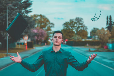 Portrait of young man standing outdoors