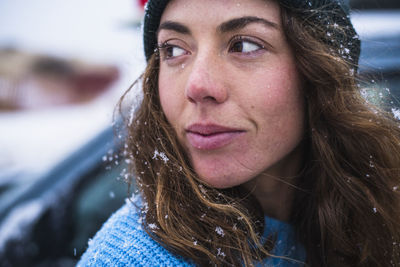 Woman surfer portrait with snow in hair